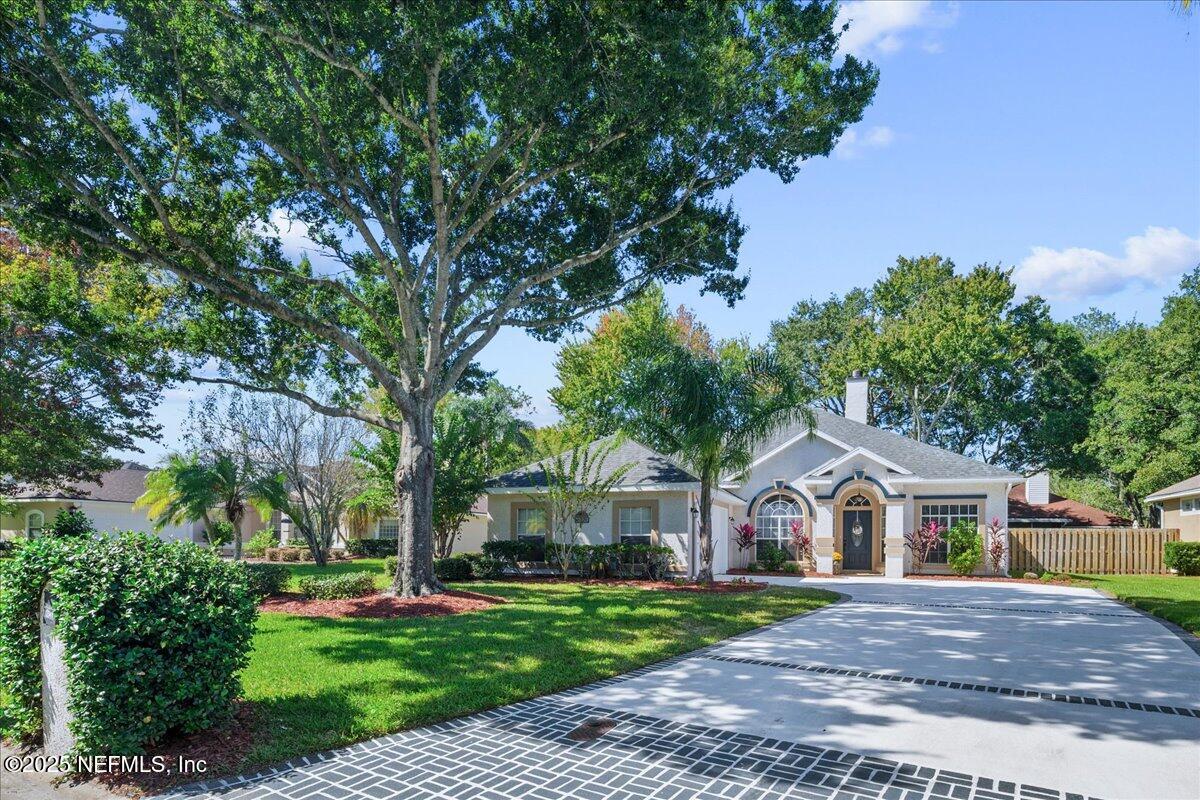 1940 Bluebonnet Way Fleming Island, FL 32003 - Photo 1 of 44 a front view of a house with a garden