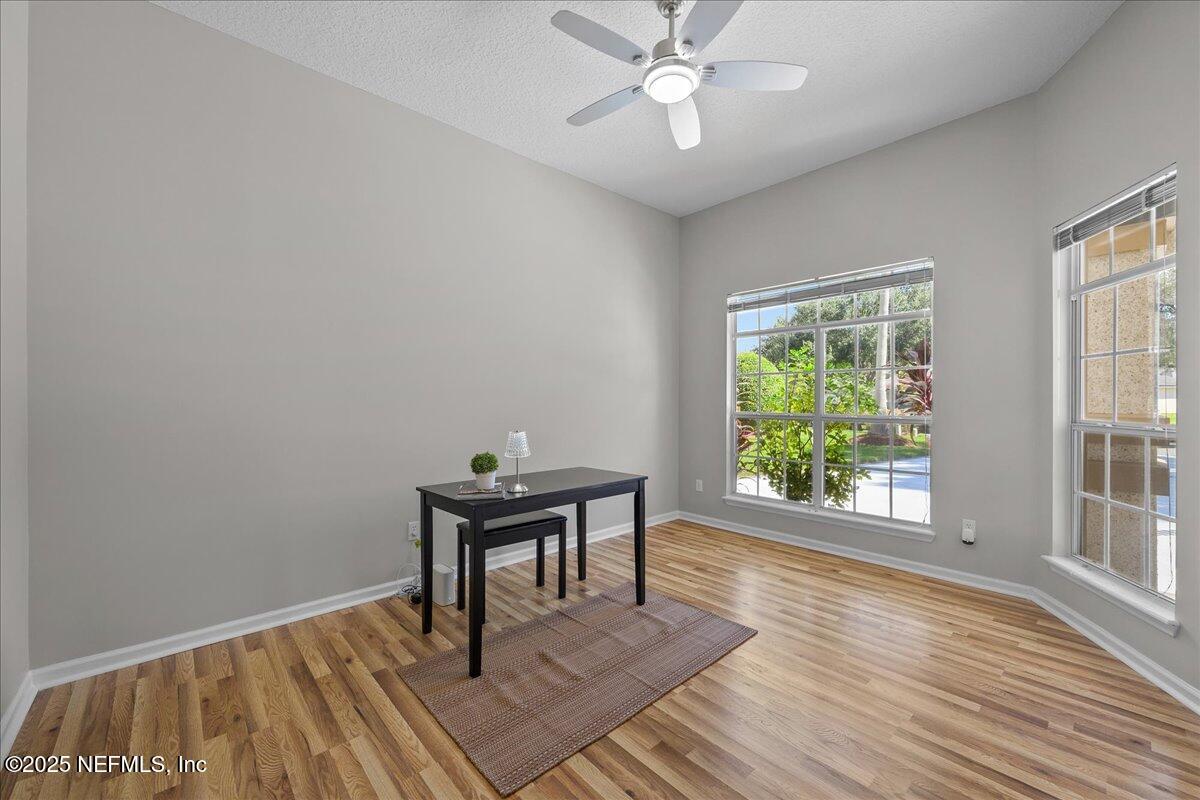 1940 Bluebonnet Way Fleming Island, FL 32003 - Photo 15 of 44 a view of a workspace room with wooden floor and windows