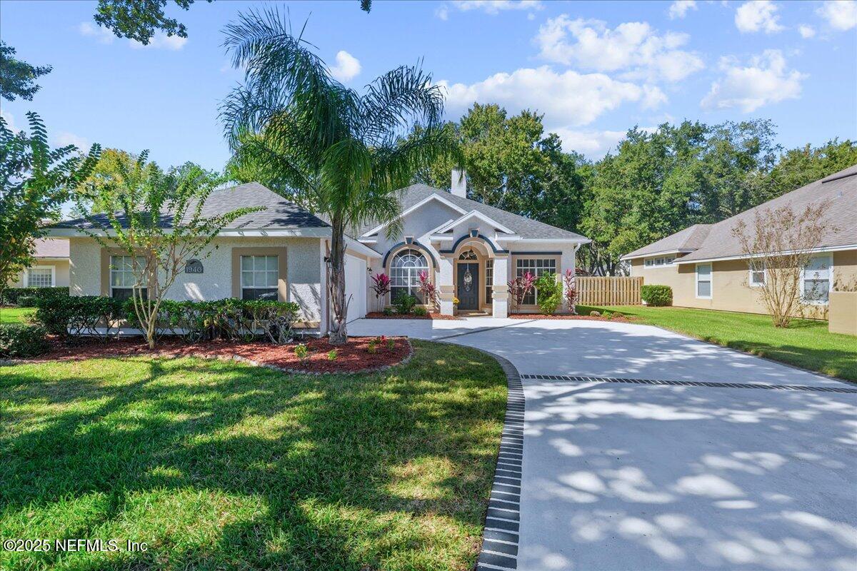 1940 Bluebonnet Way Fleming Island, FL 32003 - Photo 2 of 44 a front view of a house with a yard and porch