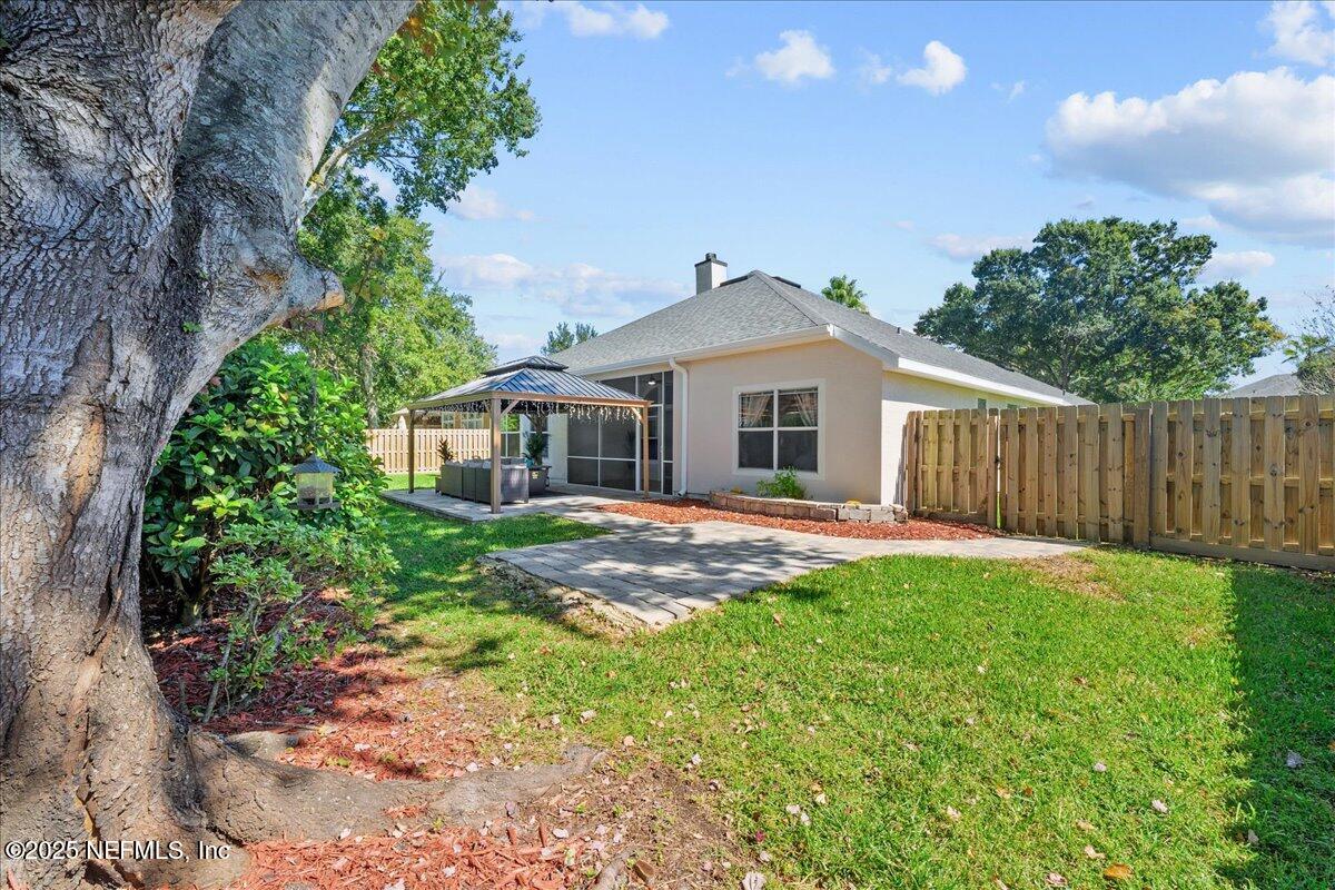 1940 Bluebonnet Way Fleming Island, FL 32003 - Photo 28 of 44 a front view of a house with a yard