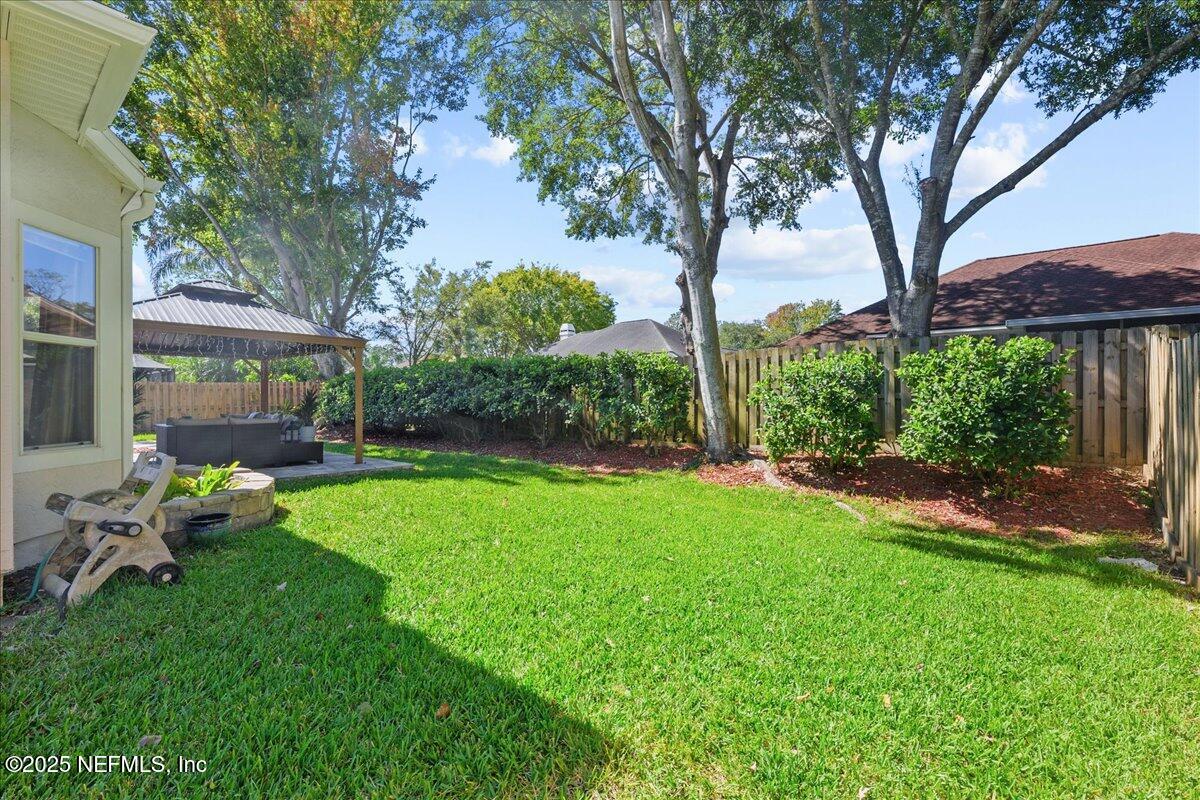 1940 Bluebonnet Way Fleming Island, FL 32003 - Photo 31 of 44 a view of a chair and table in backyard of the house