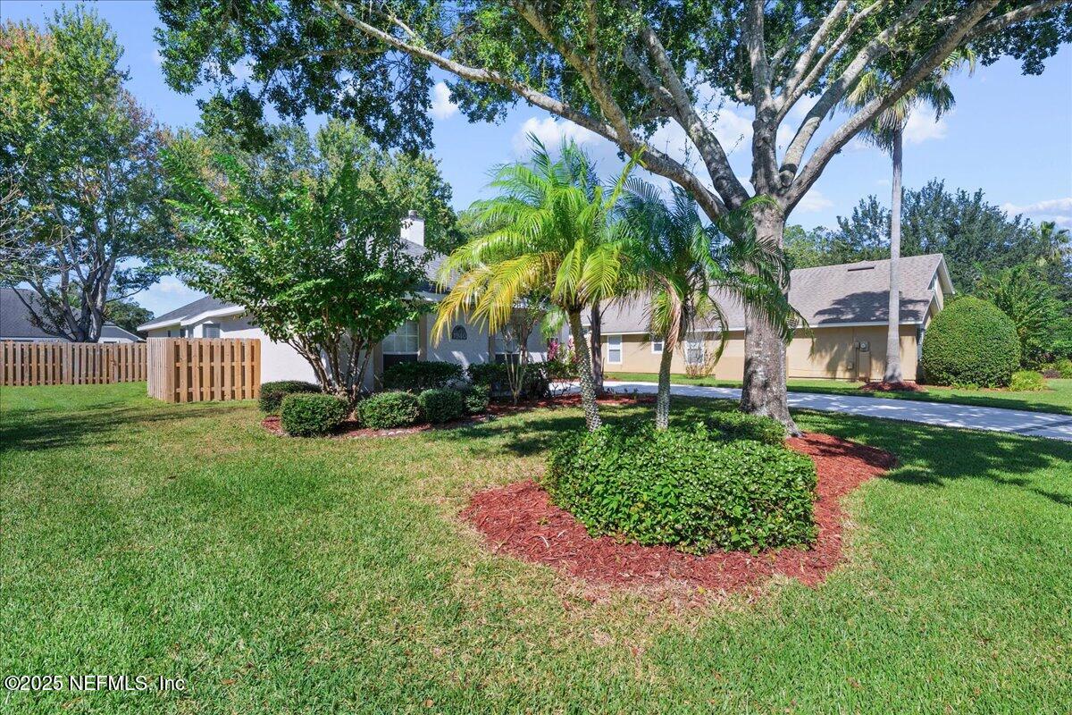 1940 Bluebonnet Way Fleming Island, FL 32003 - Photo 4 of 44 a view of a garden with a house