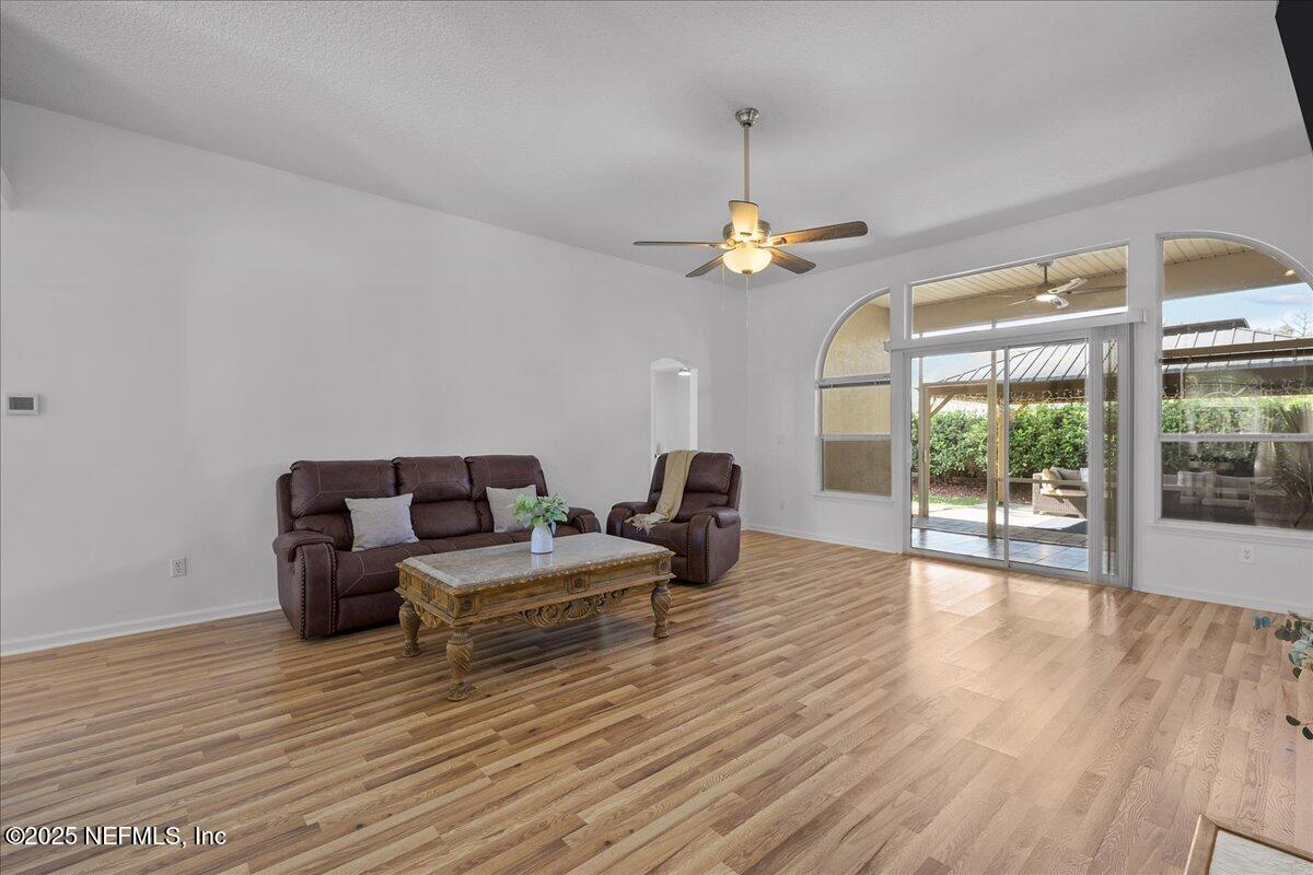 1940 Bluebonnet Way Fleming Island, FL 32003 - Photo 8 of 44 a living room with furniture and wooden floor