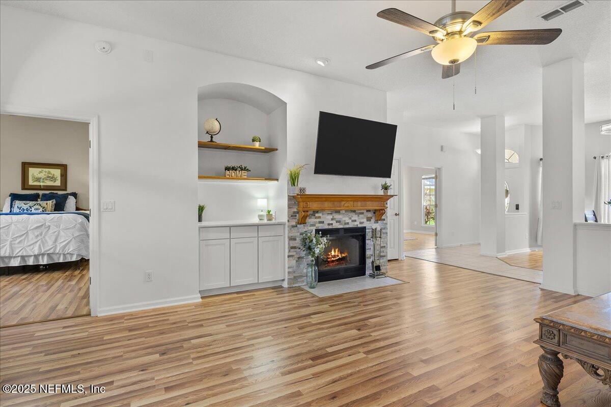 1940 Bluebonnet Way Fleming Island, FL 32003 - Photo 10 of 44 a living room with furniture and a fireplace