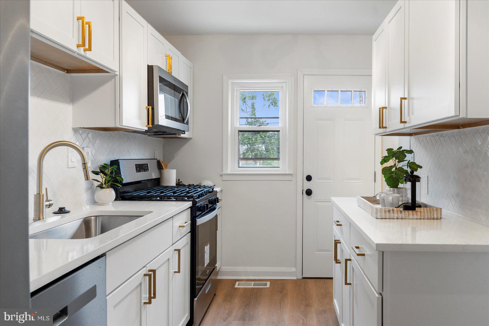 2210 Walshire Avenue Baltimore, MD 21214 - Photo 18 of 42 a kitchen with stainless steel appliances granite countertop a sink stove and cabinets