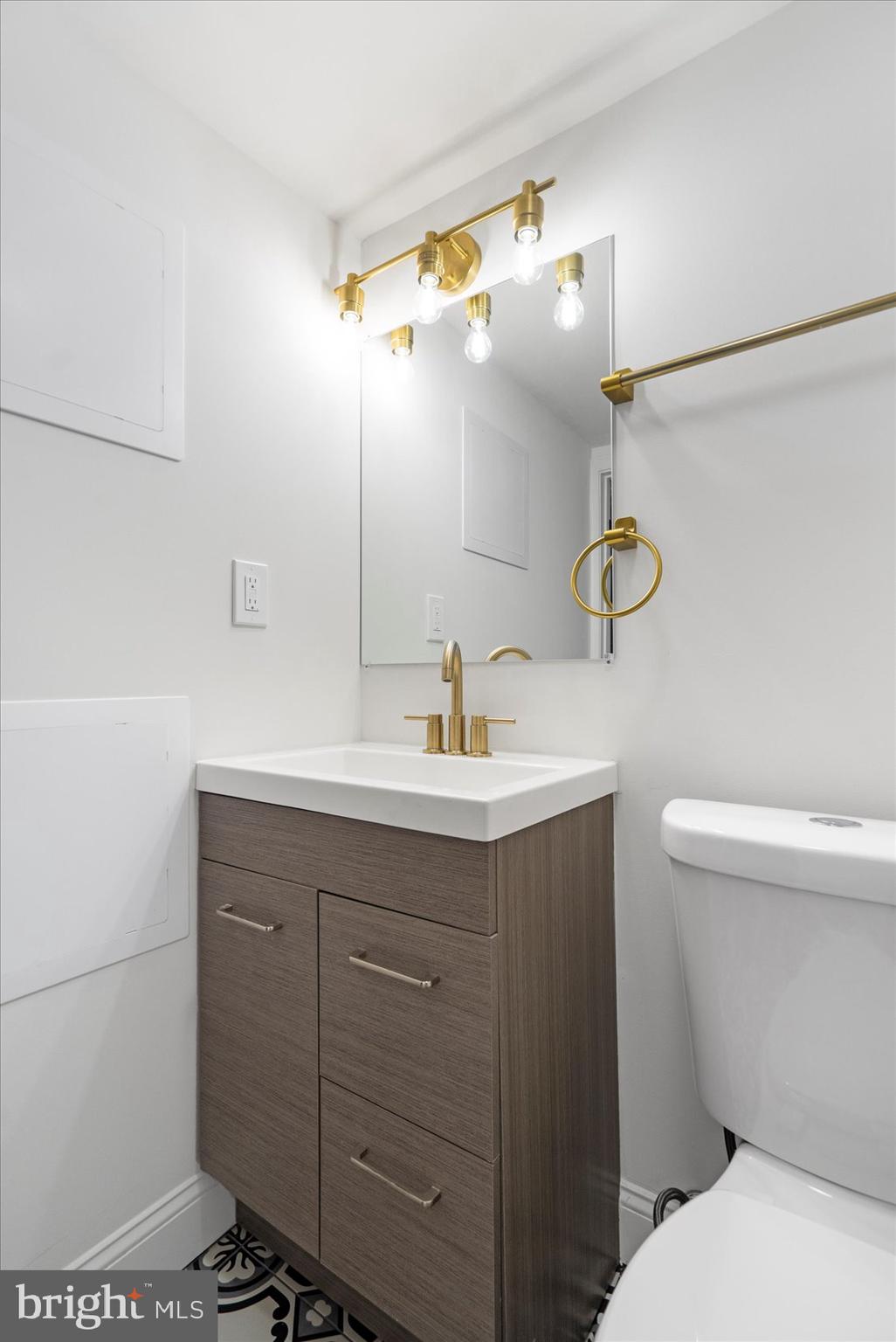 2210 Walshire Avenue Baltimore, MD 21214 - Photo 23 of 42 a bathroom with a sink a toilet and a mirror