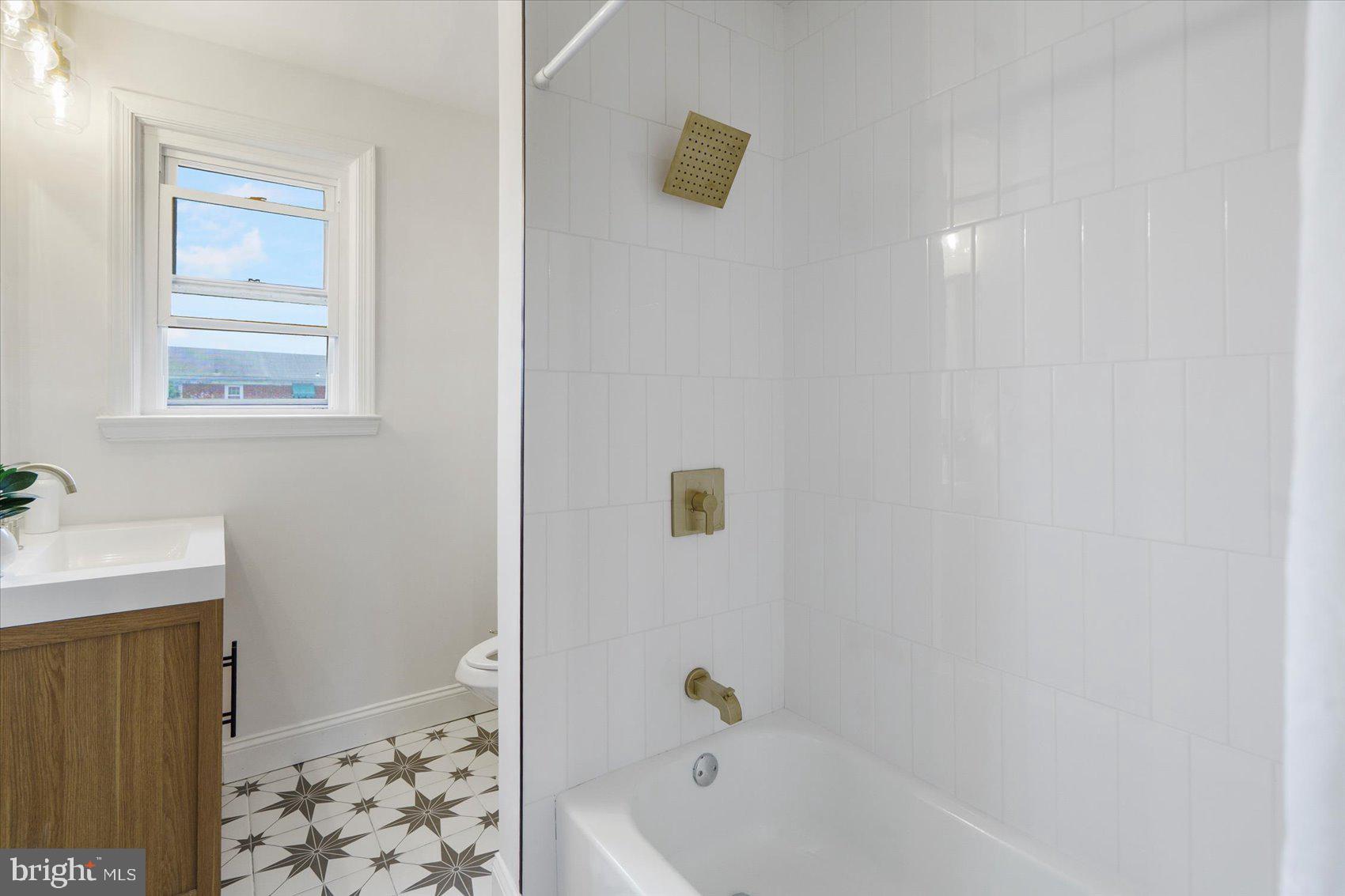 2210 Walshire Avenue Baltimore, MD 21214 - Photo 35 of 42 a bathroom with a bathtub and a shower