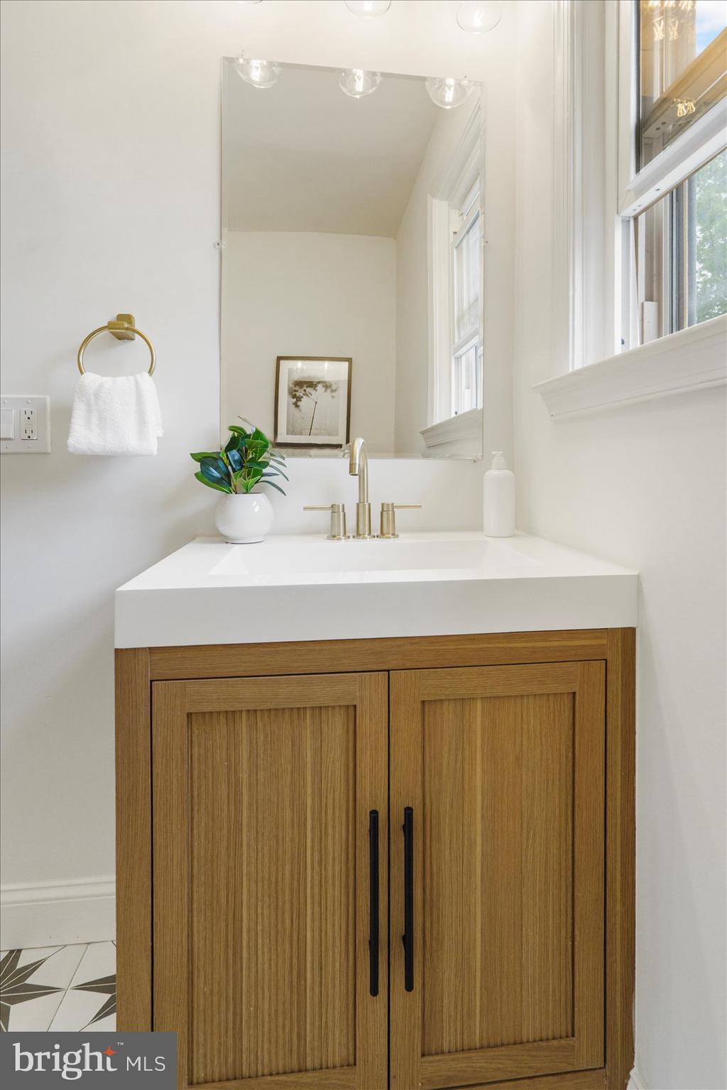 2210 Walshire Avenue Baltimore, MD 21214 - Photo 36 of 42 a bathroom with a sink and a mirror