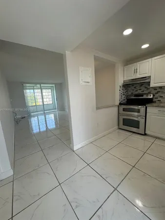 a view of kitchen with windows cabinet and windows