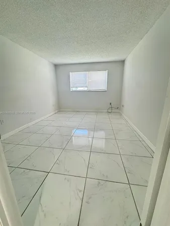 a view of an empty room and a window