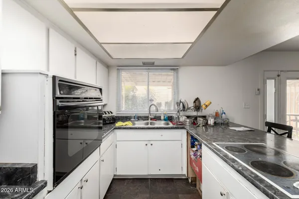 a kitchen with a sink stove and cabinets