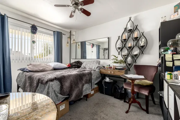 a bed room with a bed and a chair