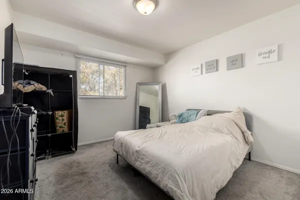 a bedroom with a bed and a window