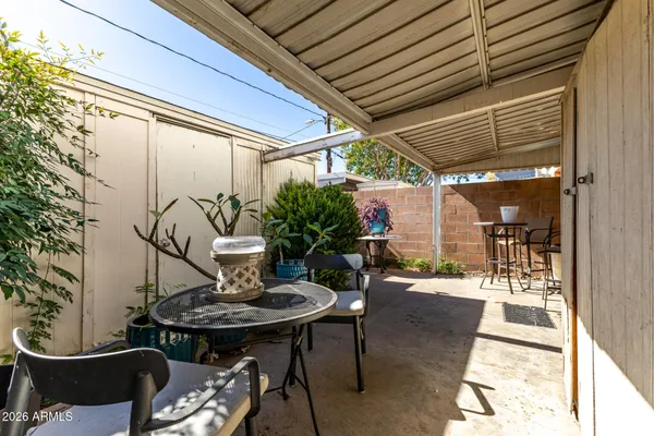 a view of a patio with table and chairs and potted plants