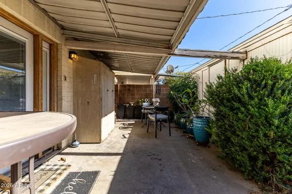 a view of a patio with table and chairs and potted plants