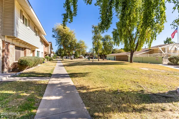 a swimming pool with an outdoor space and seating area