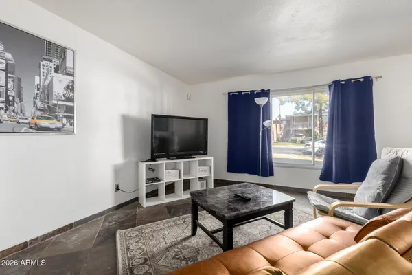 a living room with furniture and a flat screen tv