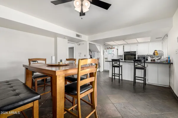 a dining room with furniture and a kitchen view