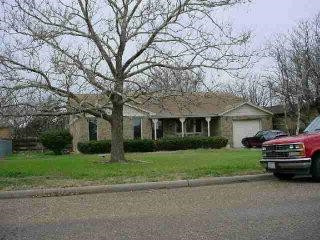 1505 Ave I Ralls, TX 79357 - Photo 1 of 1 a front view of a house with a garden and trees
