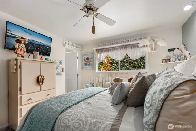 a bedroom with a bed and a large mirror