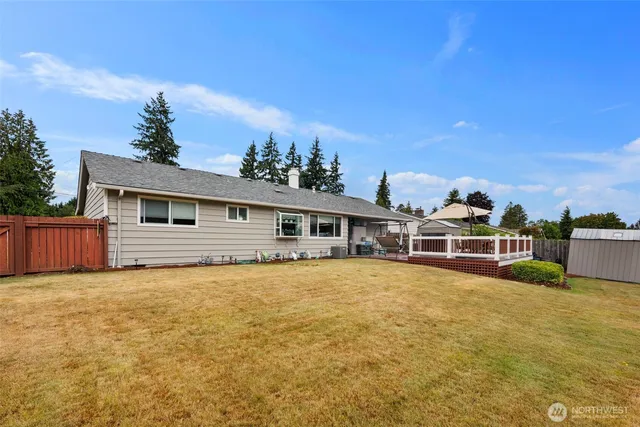 a view of a house with a big yard and potted plants