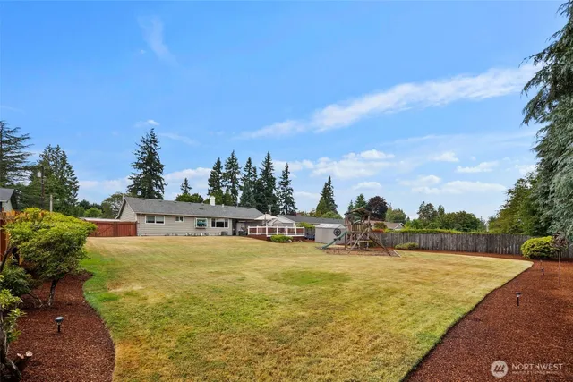 a view of a swimming pool with an outdoor seating and a garden