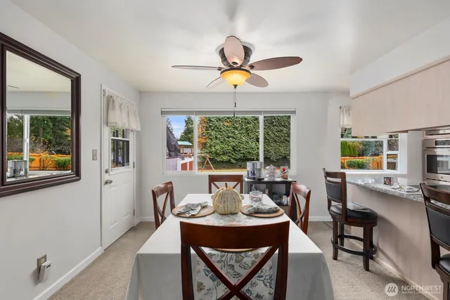 a dining room with furniture a chandelier and window