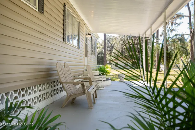 a balcony with chairs and with a swing