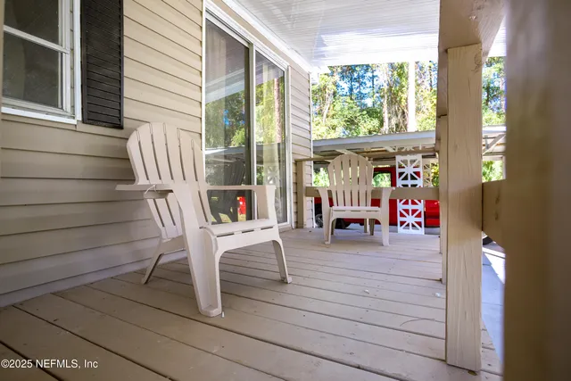 a kitchen with granite countertop a refrigerator a sink a stove and wooden cabinets