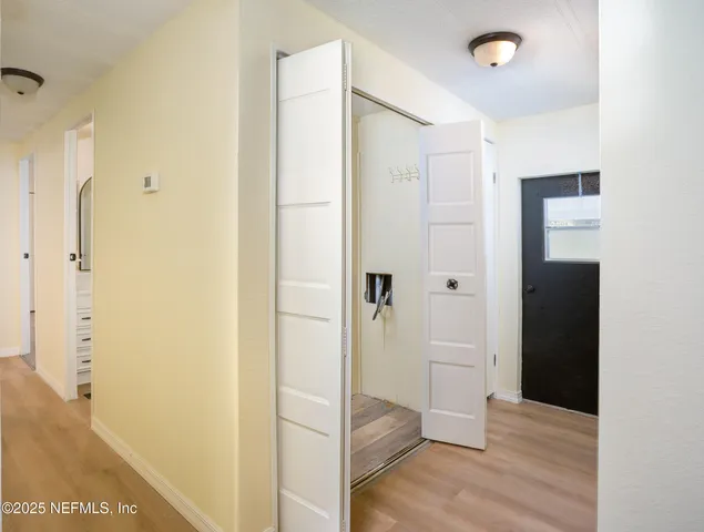 a kitchen with granite countertop a refrigerator a sink a stove and wooden cabinets