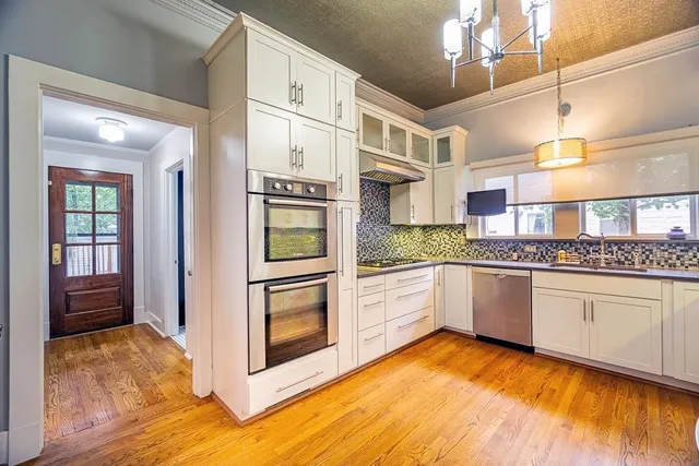 a kitchen with stainless steel appliances granite countertop a stove and a sink