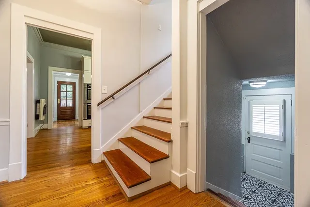 a view of entryway and hall with wooden floor