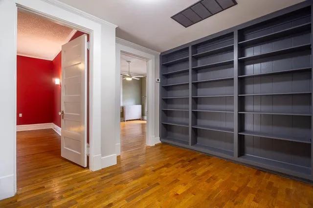 a view of walk in closet with empty racks