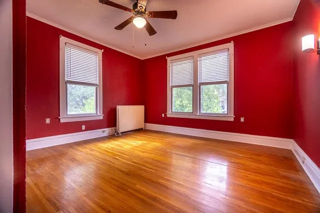 a view of a livingroom with a window and wooden floor
