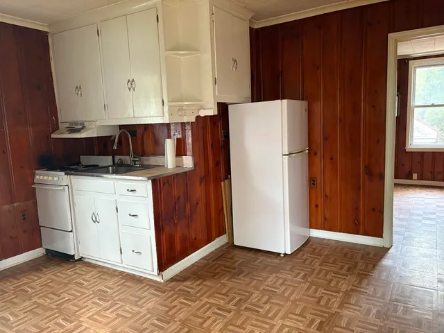 a kitchen with a refrigerator and cabinets