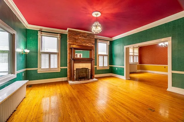 a view of an empty room with a fireplace and a floor to ceiling window