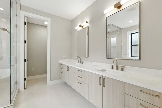 a bathroom with a double vanity sink mirror and double