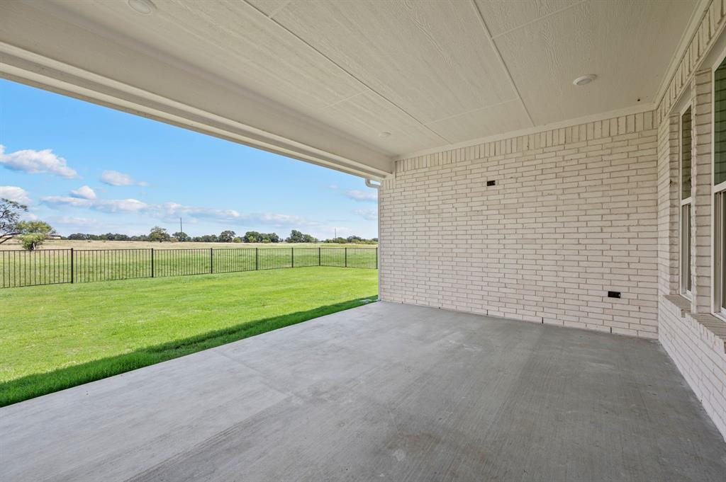2705 Gospel Road Tolar, TX 76476 - Photo 26 of 36 Covered concrete patio with white brick exterior