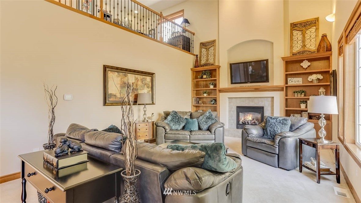 21131 37th Avenue Southeast Bothell, WA 98021 - Photo 19 of 40 a living room with furniture a flat screen tv and a fireplace
