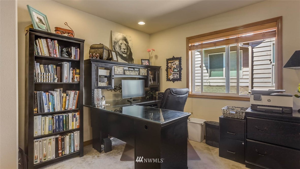 21131 37th Avenue Southeast Bothell, WA 98021 - Photo 24 of 40 a view of a workspace with furniture and a bookshelf