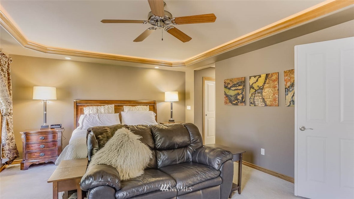 21131 37th Avenue Southeast Bothell, WA 98021 - Photo 26 of 40 a bed room with a bed and a ceiling fan