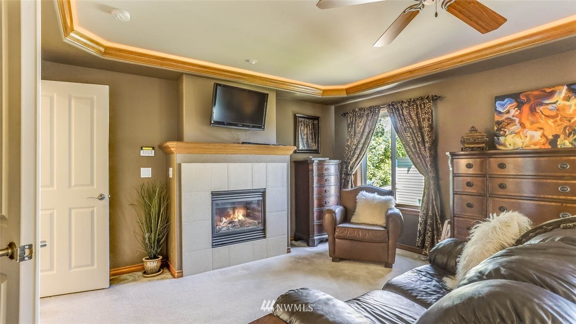 21131 37th Avenue Southeast Bothell, WA 98021 - Photo 28 of 40 a living room with furniture a fireplace and a floor to ceiling window