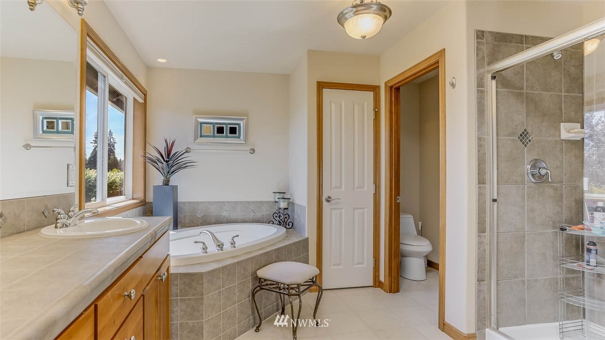 21131 37th Avenue Southeast Bothell, WA 98021 - Photo 29 of 40 a bathroom with a granite countertop sink a toilet and shower