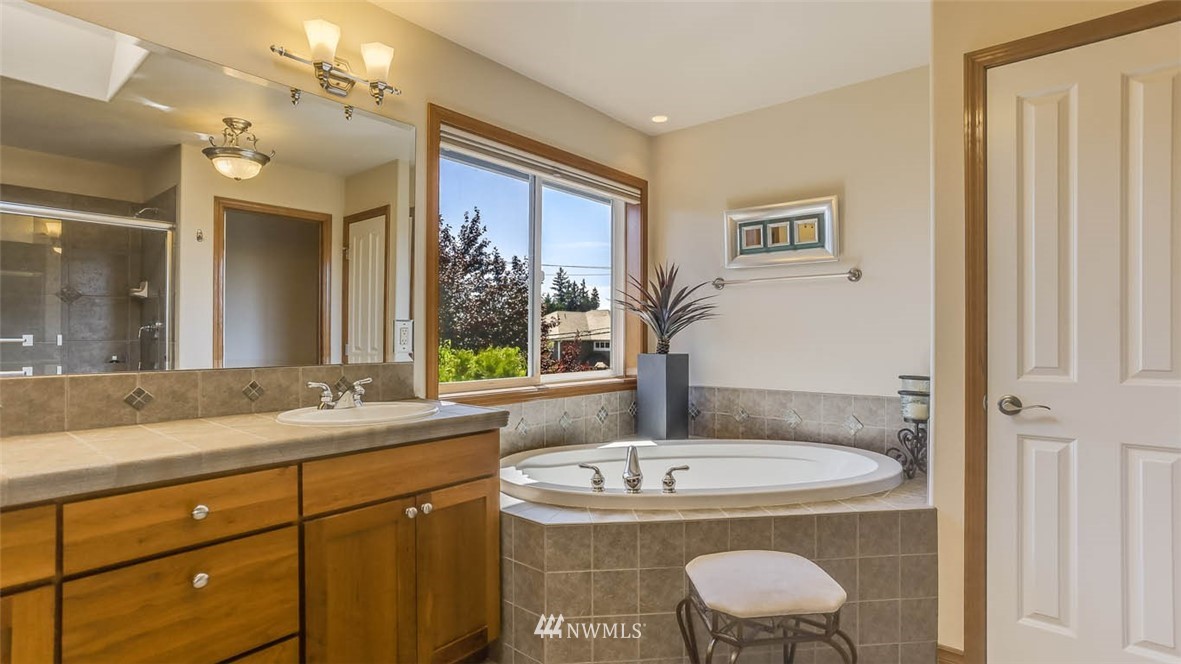 21131 37th Avenue Southeast Bothell, WA 98021 - Photo 30 of 40 a bathroom with a granite countertop sink and a mirror