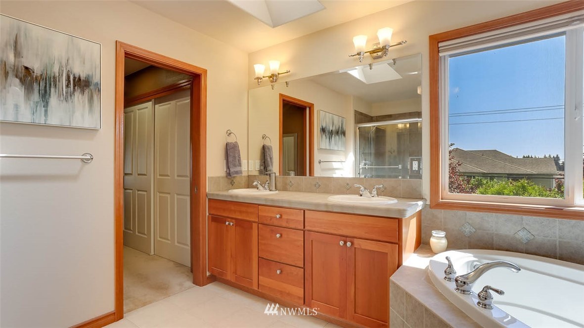 21131 37th Avenue Southeast Bothell, WA 98021 - Photo 31 of 40 a bathroom with a tub sink and mirror