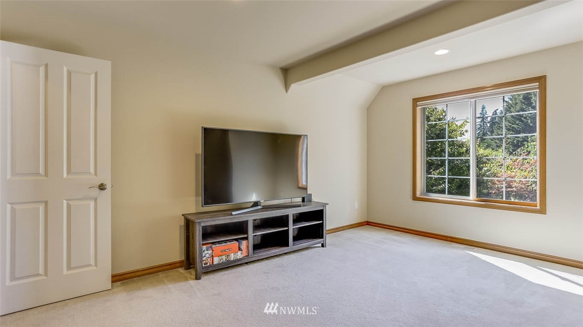 21131 37th Avenue Southeast Bothell, WA 98021 - Photo 33 of 40 an empty room with furniture and a flat screen tv