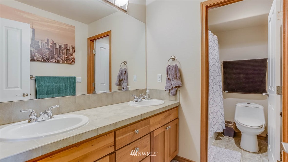 21131 37th Avenue Southeast Bothell, WA 98021 - Photo 34 of 40 a bathroom with a granite countertop sink vanity mirror and toilet
