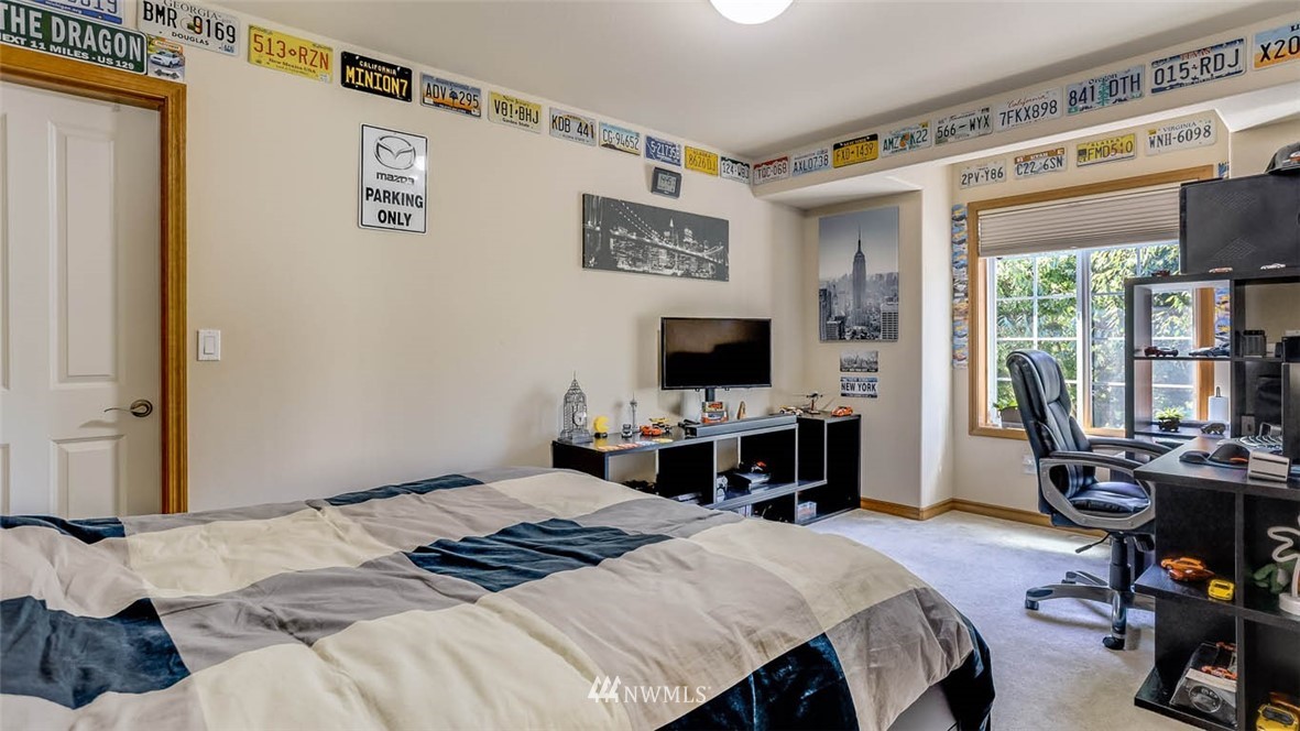 21131 37th Avenue Southeast Bothell, WA 98021 - Photo 35 of 40 a bedroom with a bed and a flat screen tv