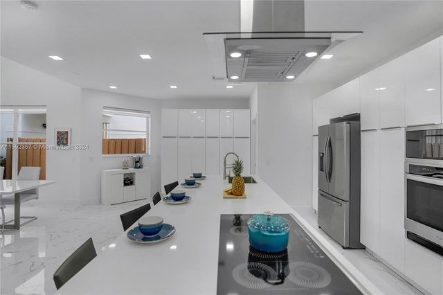a kitchen with a sink appliances and cabinets