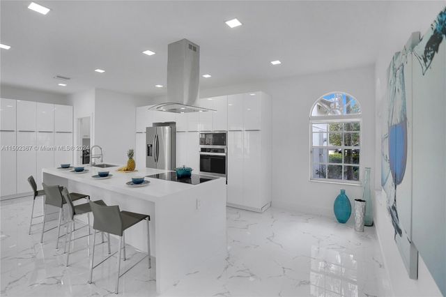 a large kitchen with a table and chairs in it